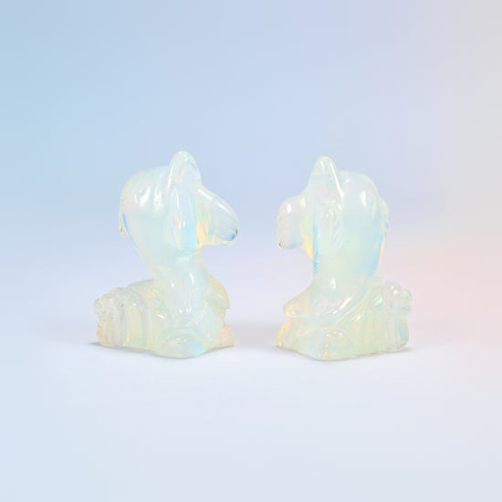 Two opalite dolphin carvings side by side, 2 inch, milky white with blue shimmer