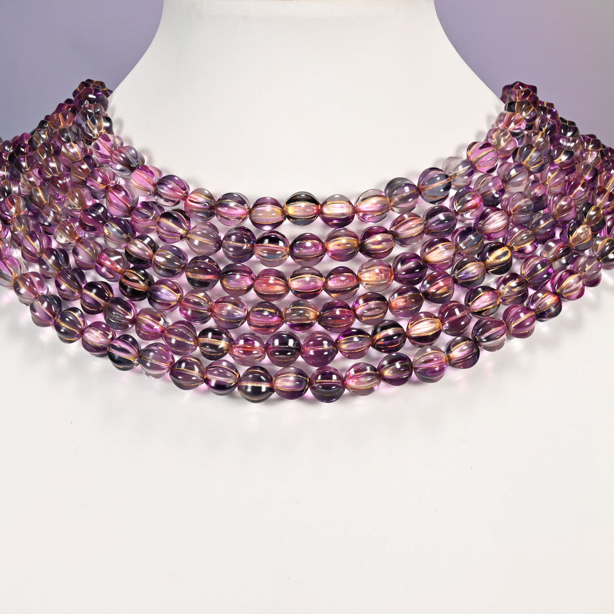 Pink blue gold pumpkin glass beads arranged as a layered collar, the 16 inch strands curving in even rows.