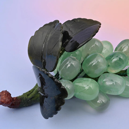 Fluorite grape cluster carving with twisted stem and jade leaves