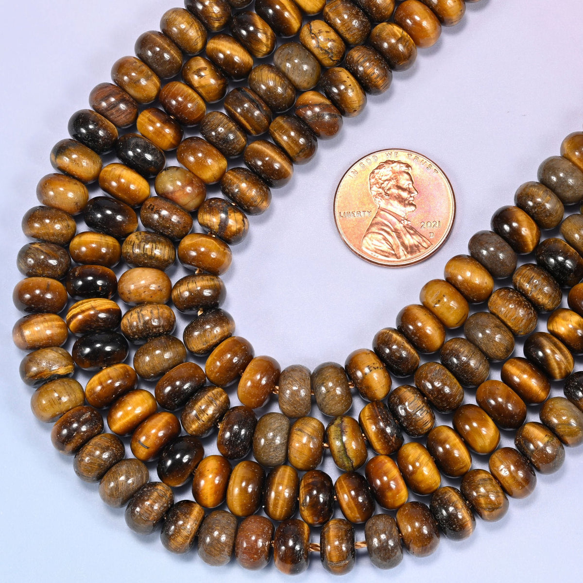 Rondelle cut Natural Tiger's Eye beads with the stone's signature chatoyant shine.