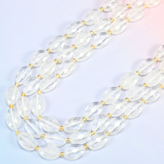 Clear quartz faceted flat oval beads in several strands curved into a wide U, water-clear quartz