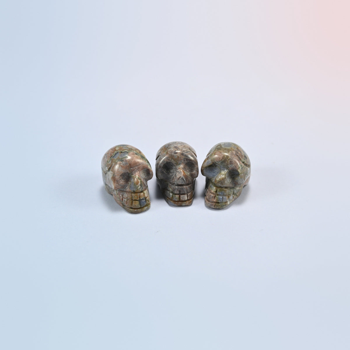 1 inch skull crystal carving in blue labradorite, gray-green natural stone with a blue flash