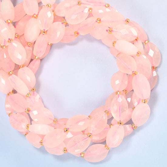 Rose quartz faceted flat oval beads coiled into overlapping loops, whole strands of soft pink stone