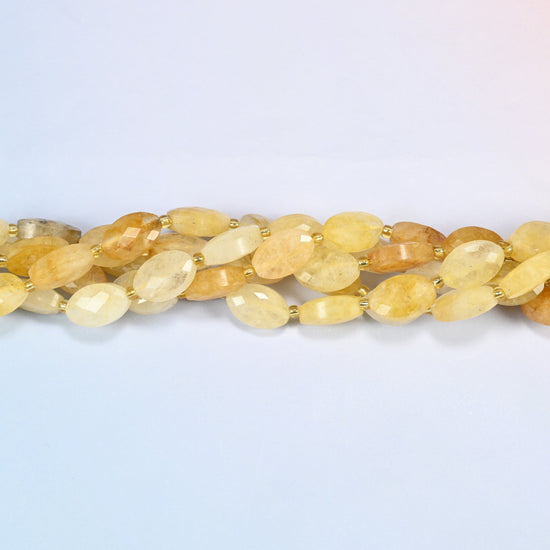 Strands of golden healer quartz faceted flat oval beads twisted together in a horizontal row