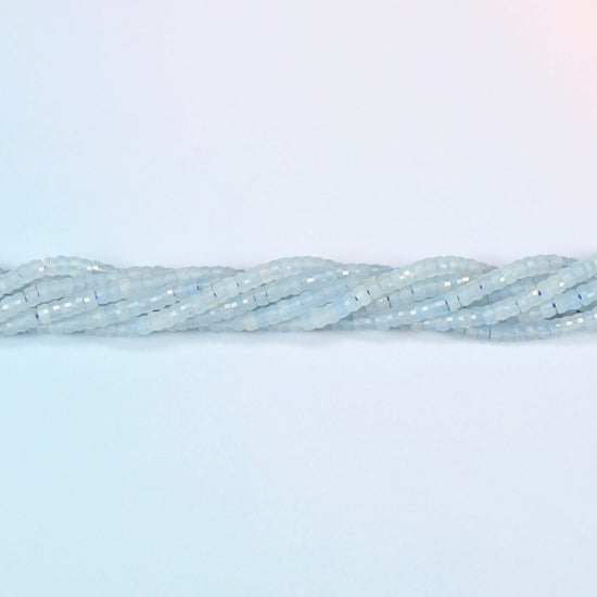 Strands of aquamarine chalcedony faceted heishi disc beads twisted together in a horizontal row