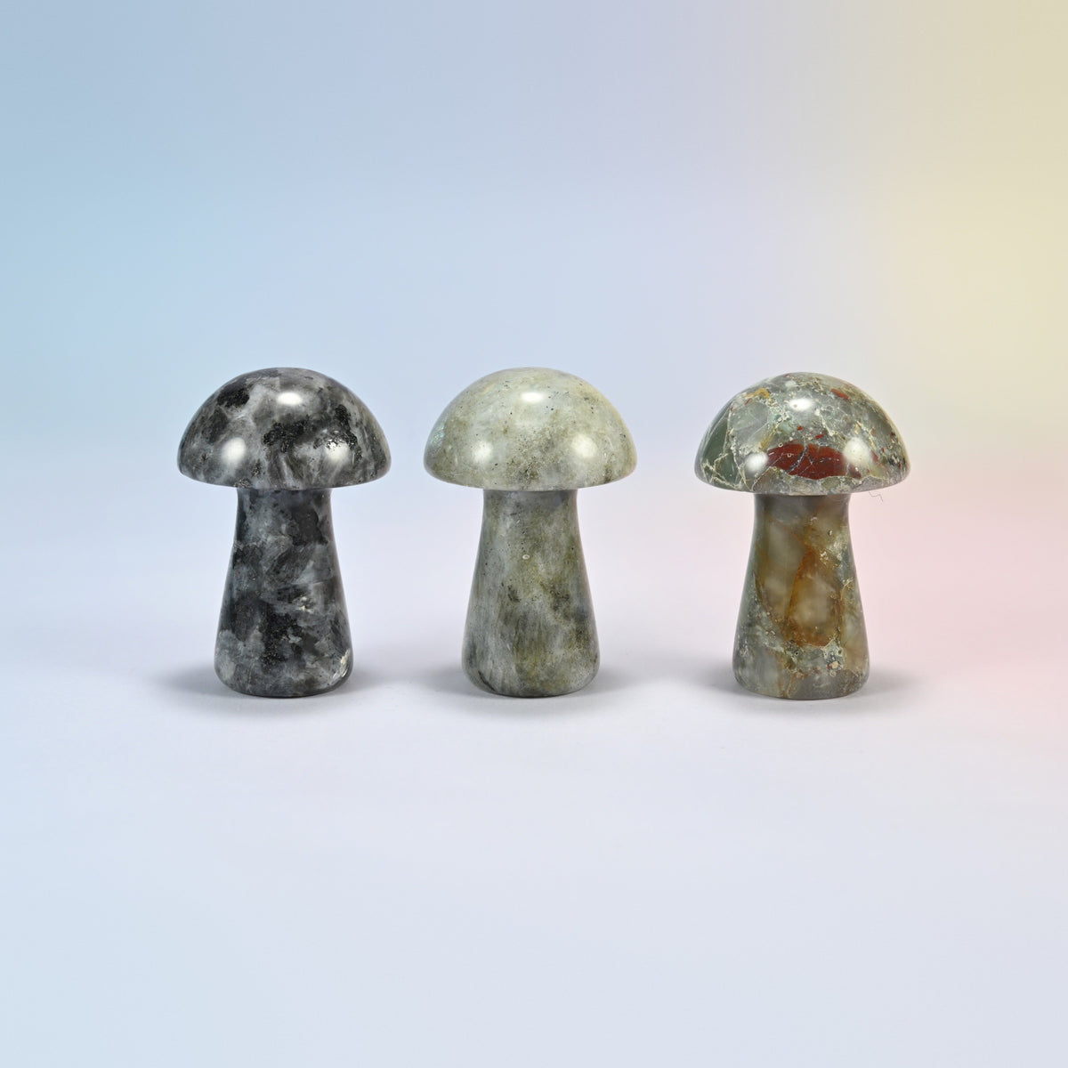 Three 2 inch mushroom crystal carvings in black labradorite, gray labradorite and African bloodstone, natural stones