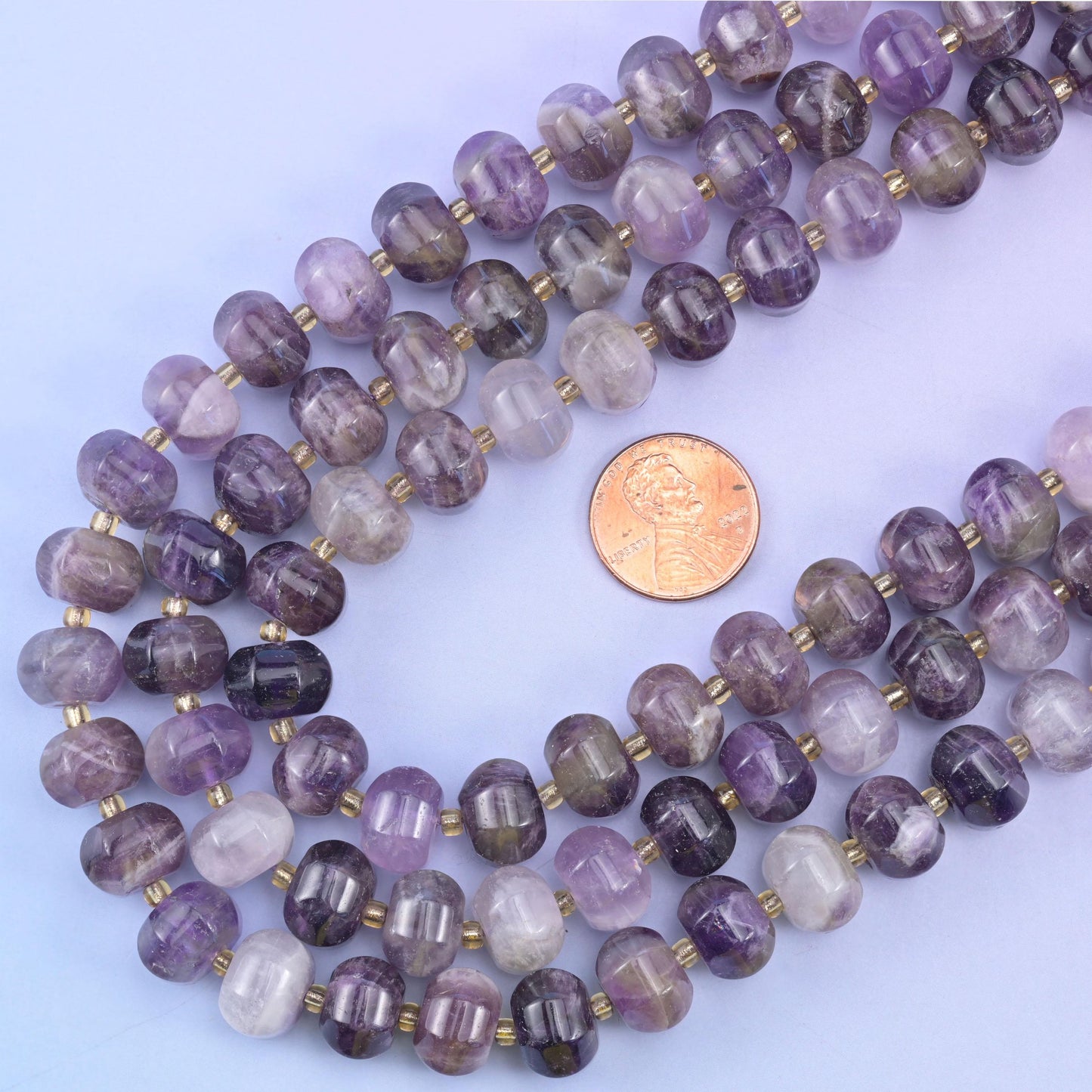 US penny resting inside the loop of the strands, giving true scale for the 12x8mm beads