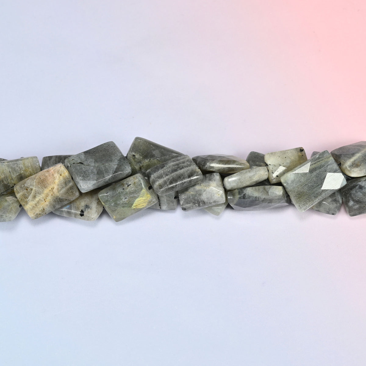 Gray Labradorite faceted flat rectangle beads in a single close run, faceting worked across the face of each tile