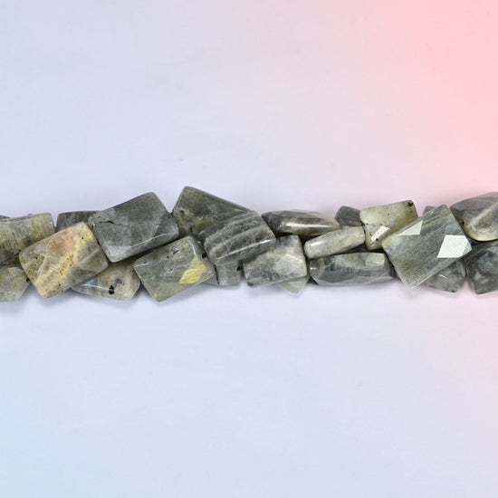 Gray Labradorite faceted flat rectangle beads in a single close run, faceting worked across the face of each tile