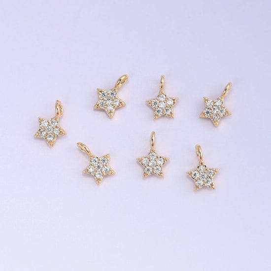Small gold charms, eight gold plated star charms arranged in two rows