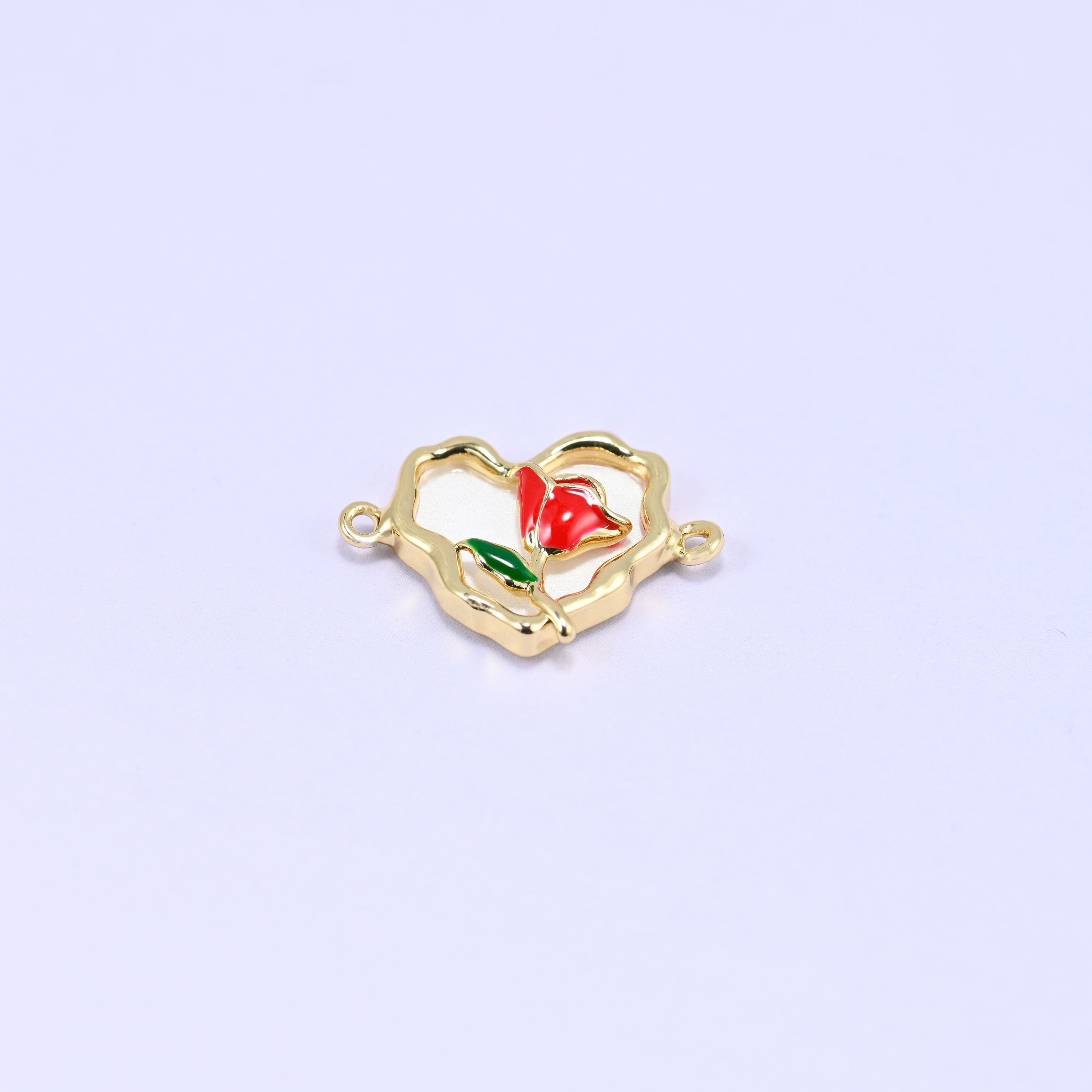 Cream-white enamel heart in an open scalloped 18K gold plated frame with a red enamel rose