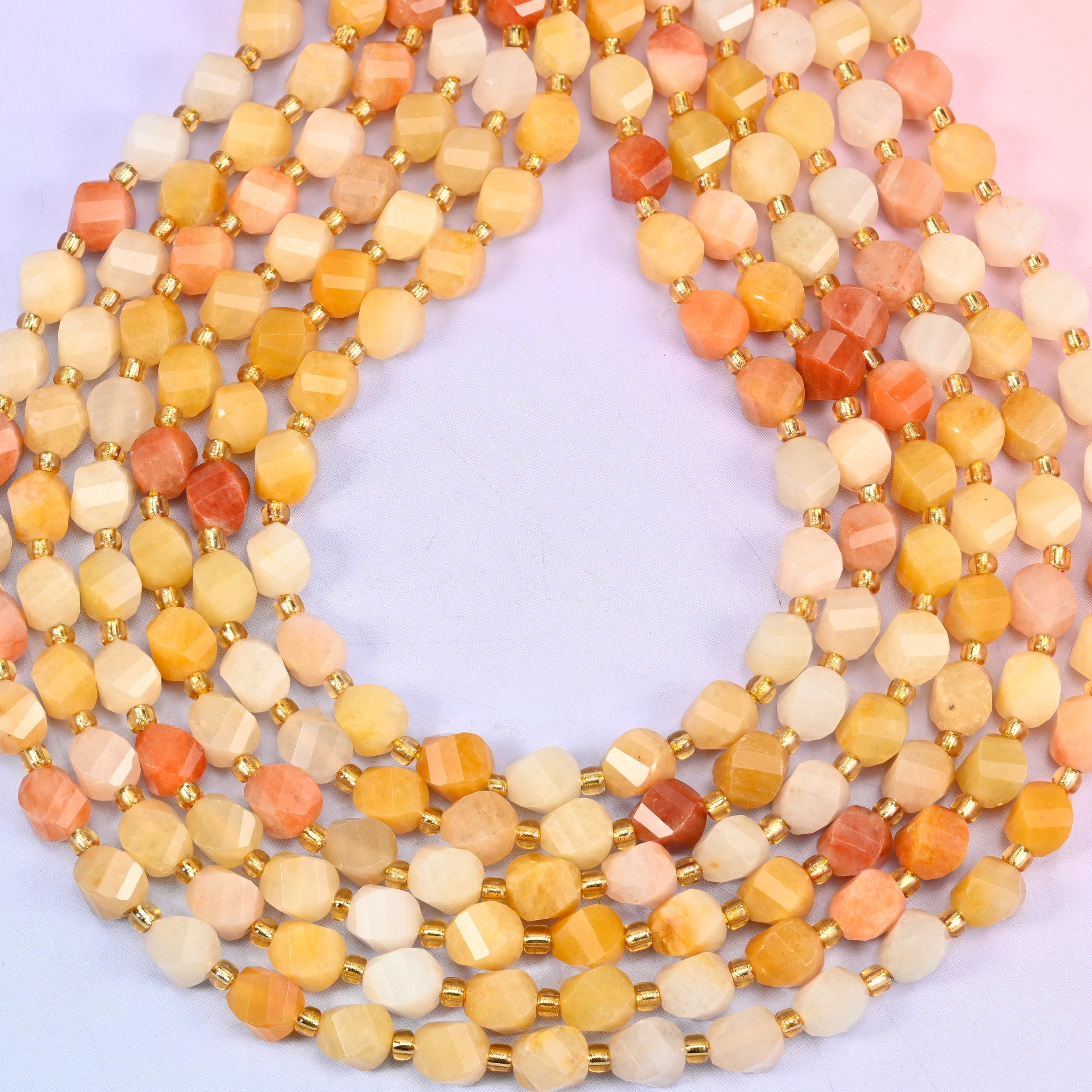Gold silk jade yellow jade beads showing a smooth waxy polished surface on each 8mm bead