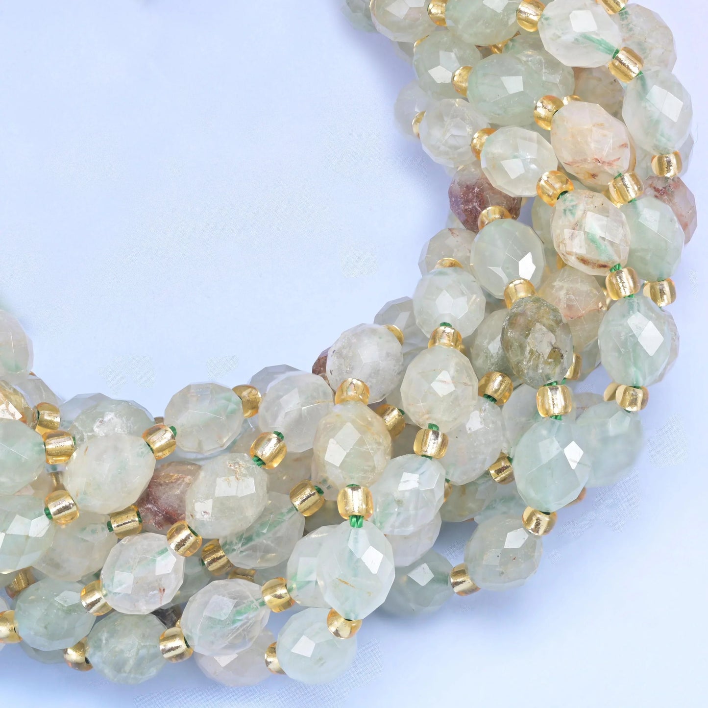 Faceted rice barrel cut green rutilated quartz beads