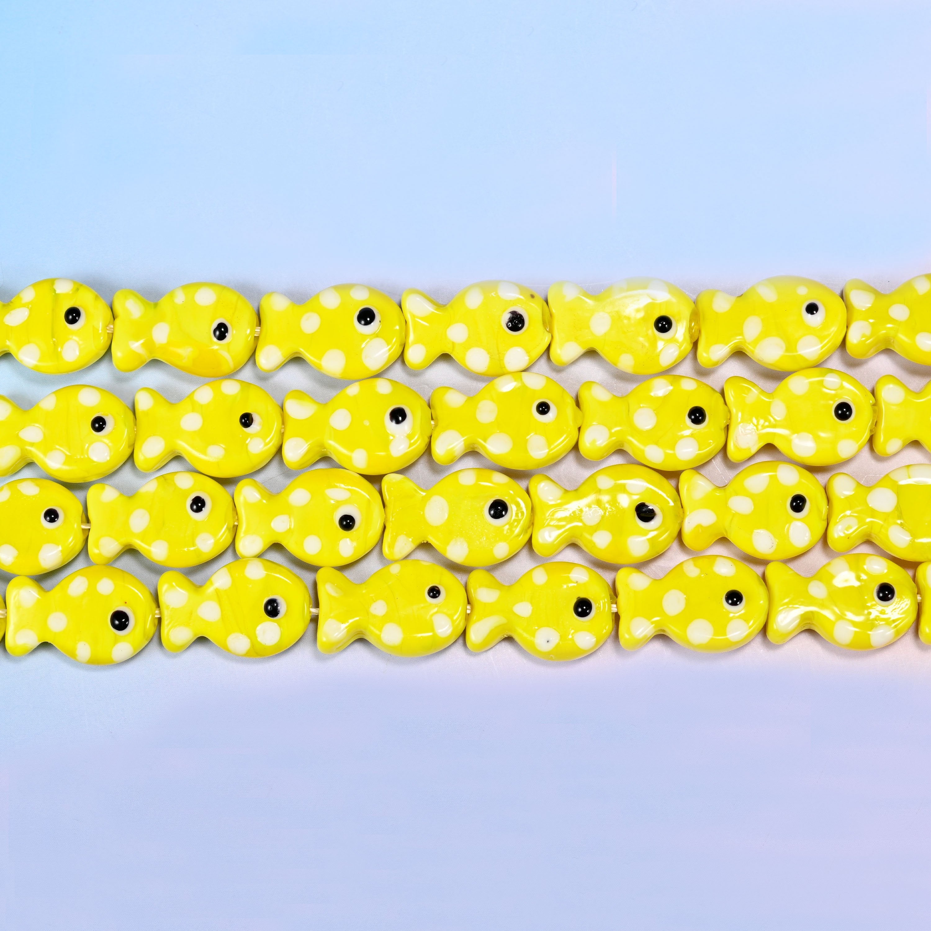 Solid lemon-yellow fish glass beads speckled with tiny white dots