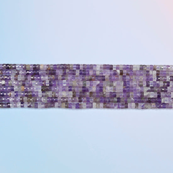 Several strands of amethyst faceted heishi disc beads laid in straight rows