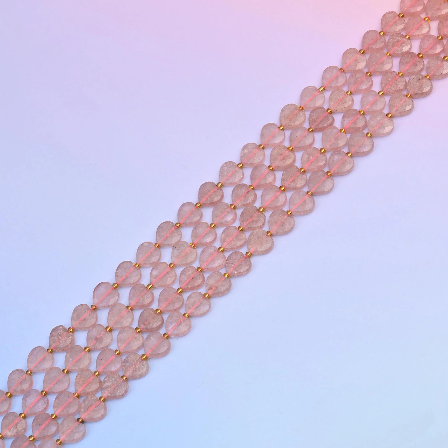 Strawberry quartz beads in dusty blush tones with reddish inclusions