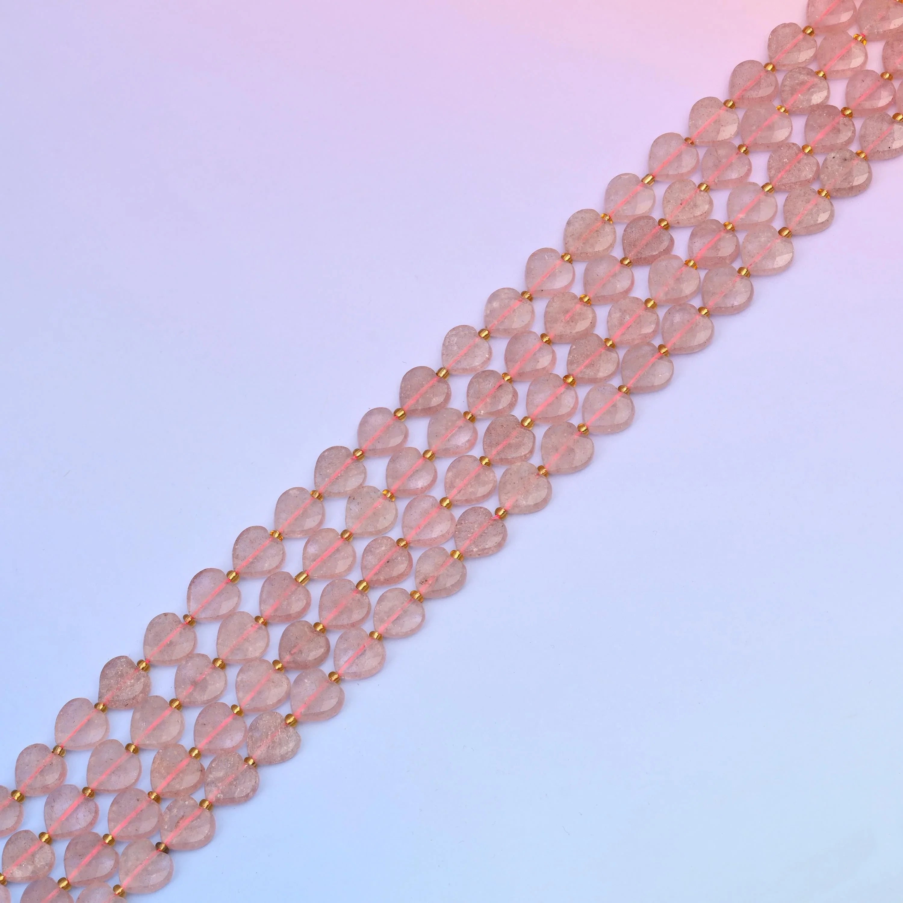 Strawberry quartz beads in dusty blush tones with reddish inclusions
