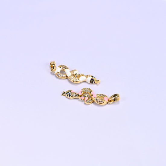 Two Enamel Snake Zirconia Charms angled across the frame, white above and pink below, showing the full length of the coiled gold plated pendants.