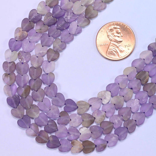 Macro detail of Amethyst bead texture and purple and lavender finish, 6mm matte beads, 15 inch strand