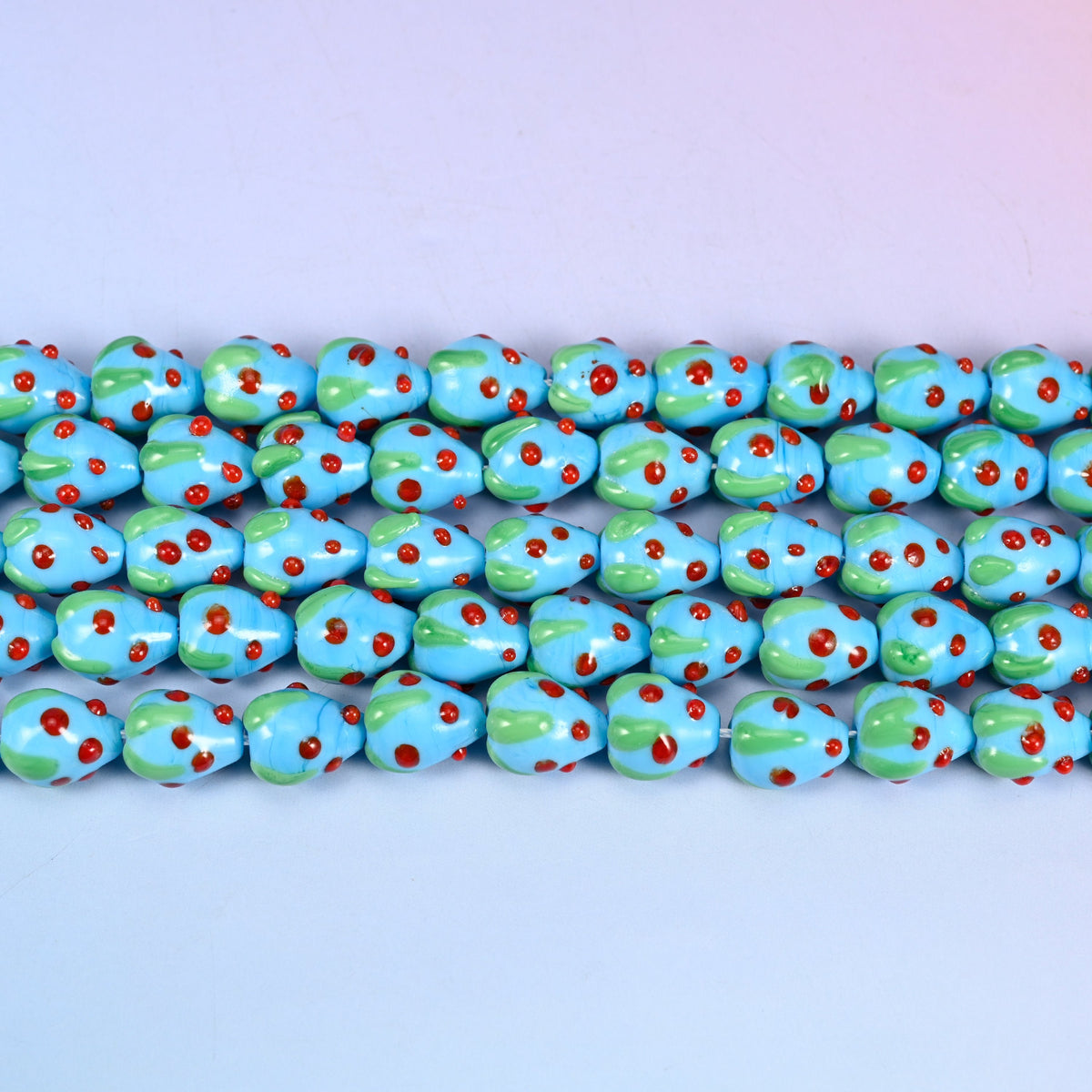 Sky Blue Strawberry Glass Beads 15.5x12mm in sky blue with red dots and a green leaf