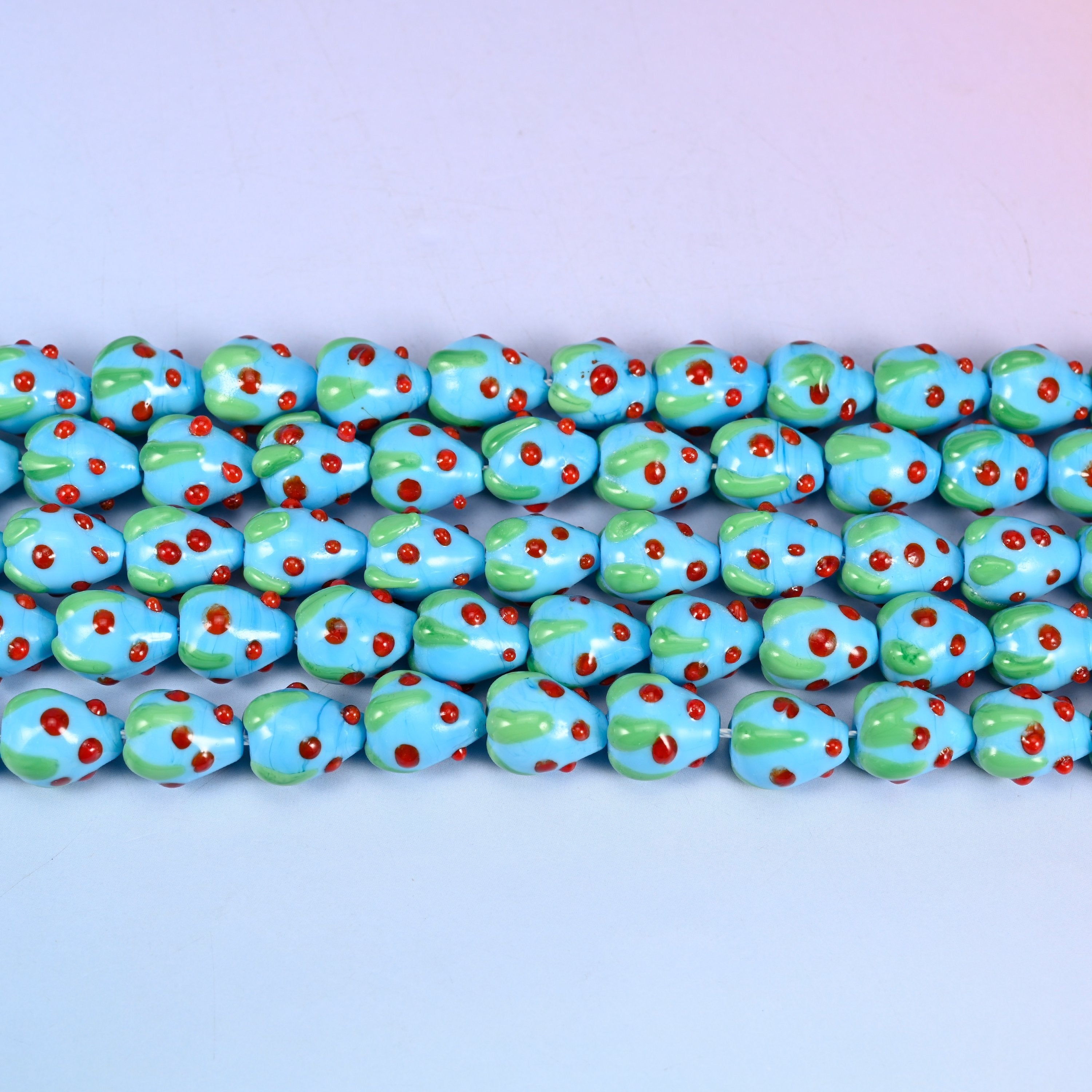 Sky Blue Strawberry Glass Beads 15.5x12mm in sky blue with red dots and a green leaf