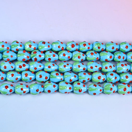 Sky Blue Strawberry Glass Beads 15.5x12mm in sky blue with red dots and a green leaf