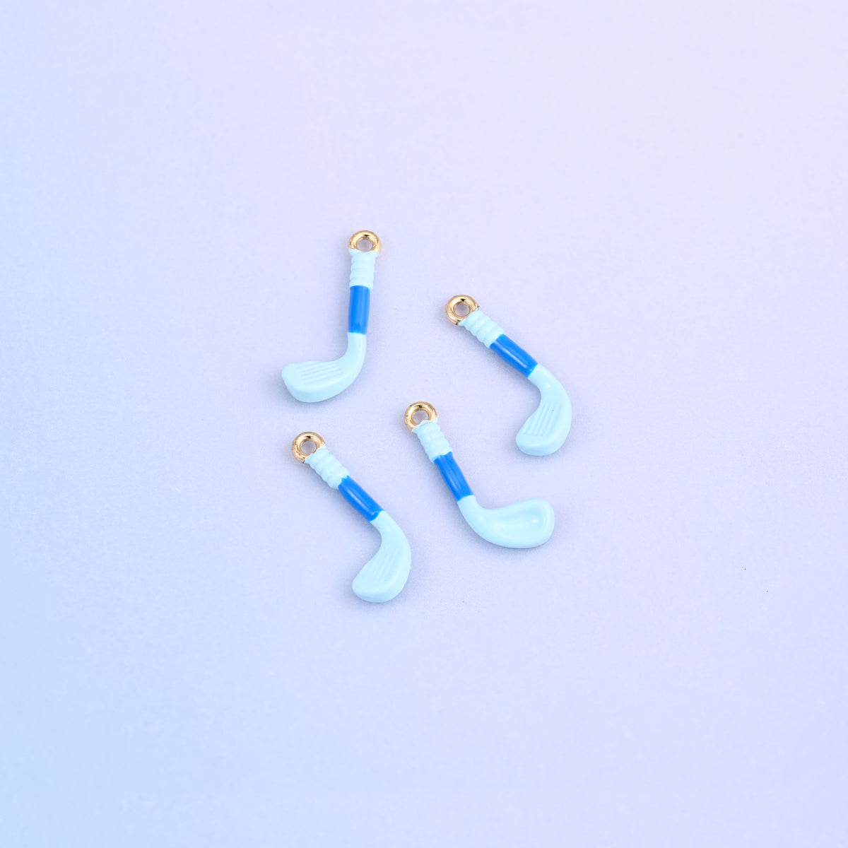 Four light blue golf club charms with blue enamel grips, 18K gold plated brass.