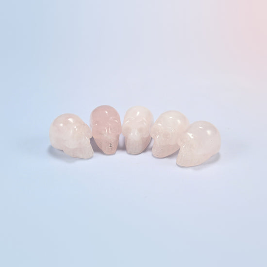 1 inch skull crystal carving in rose quartz, light pink natural stone