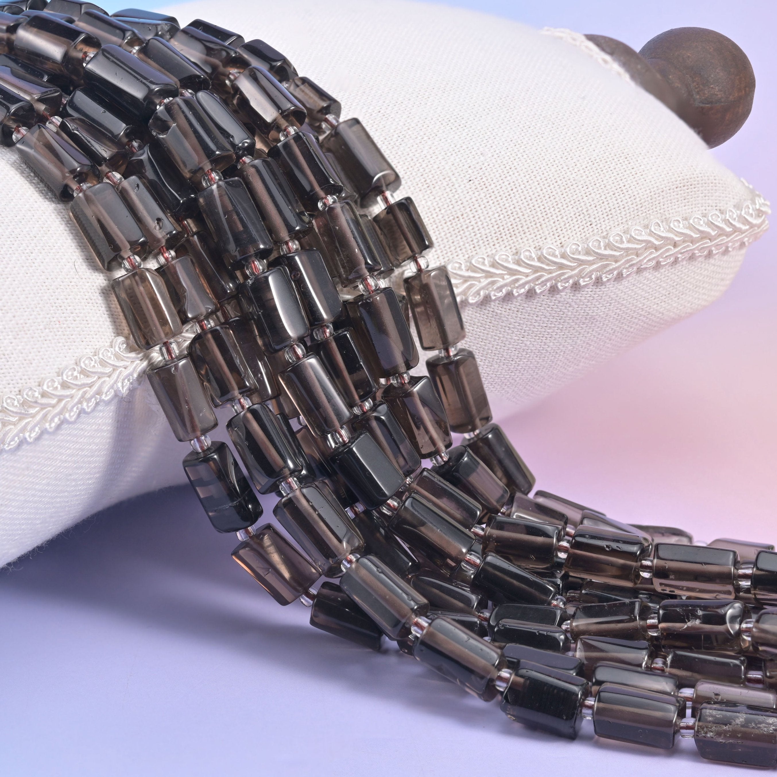 Natural Smoky Quartz faceted tube beads with deep, earthy translucent tones.