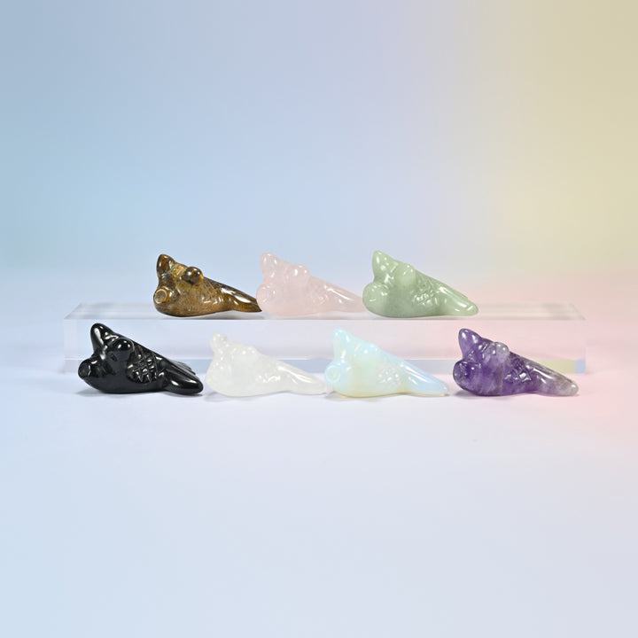 Seven 1.5 inch goldfish crystal carvings in natural tiger eye, rose quartz, green aventurine, black obsidian, clear quartz, amethyst and opalite
