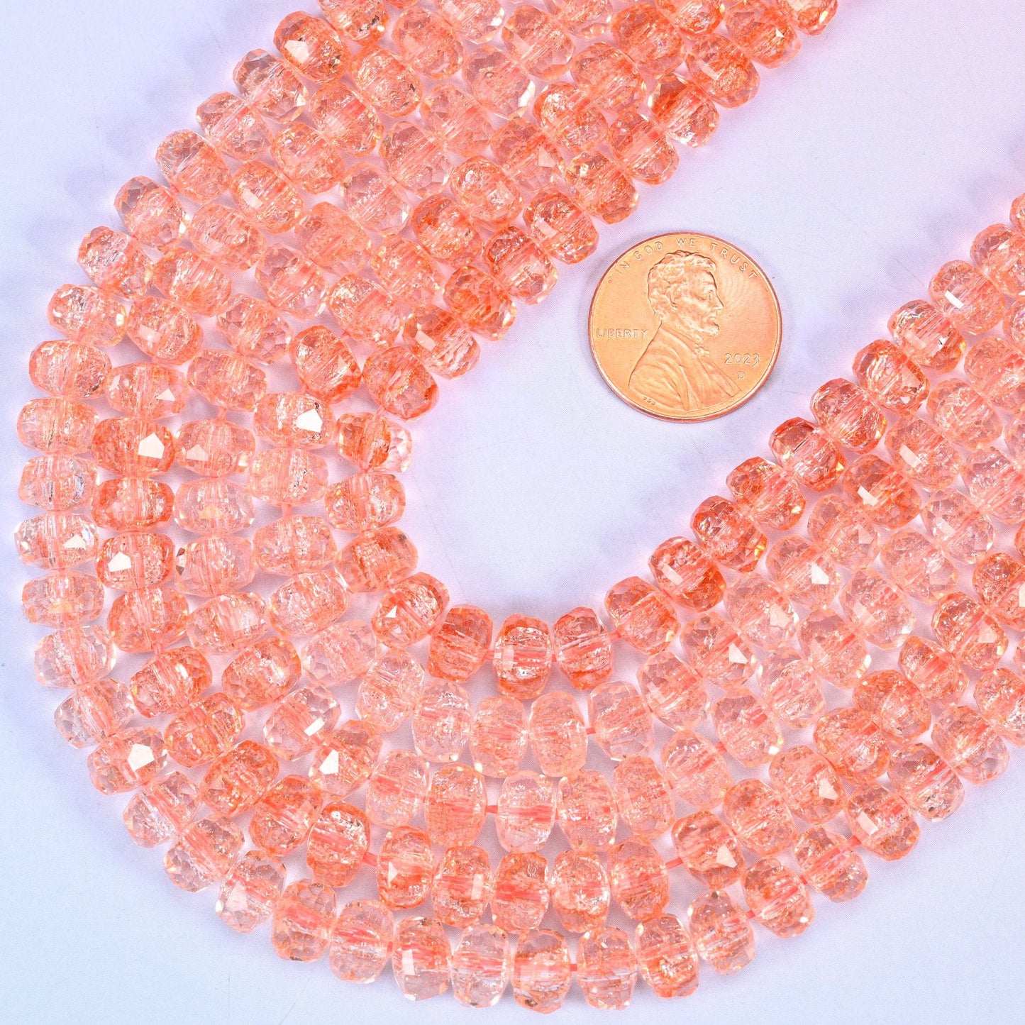 Faceted rondelle cut transparent orange glass beads