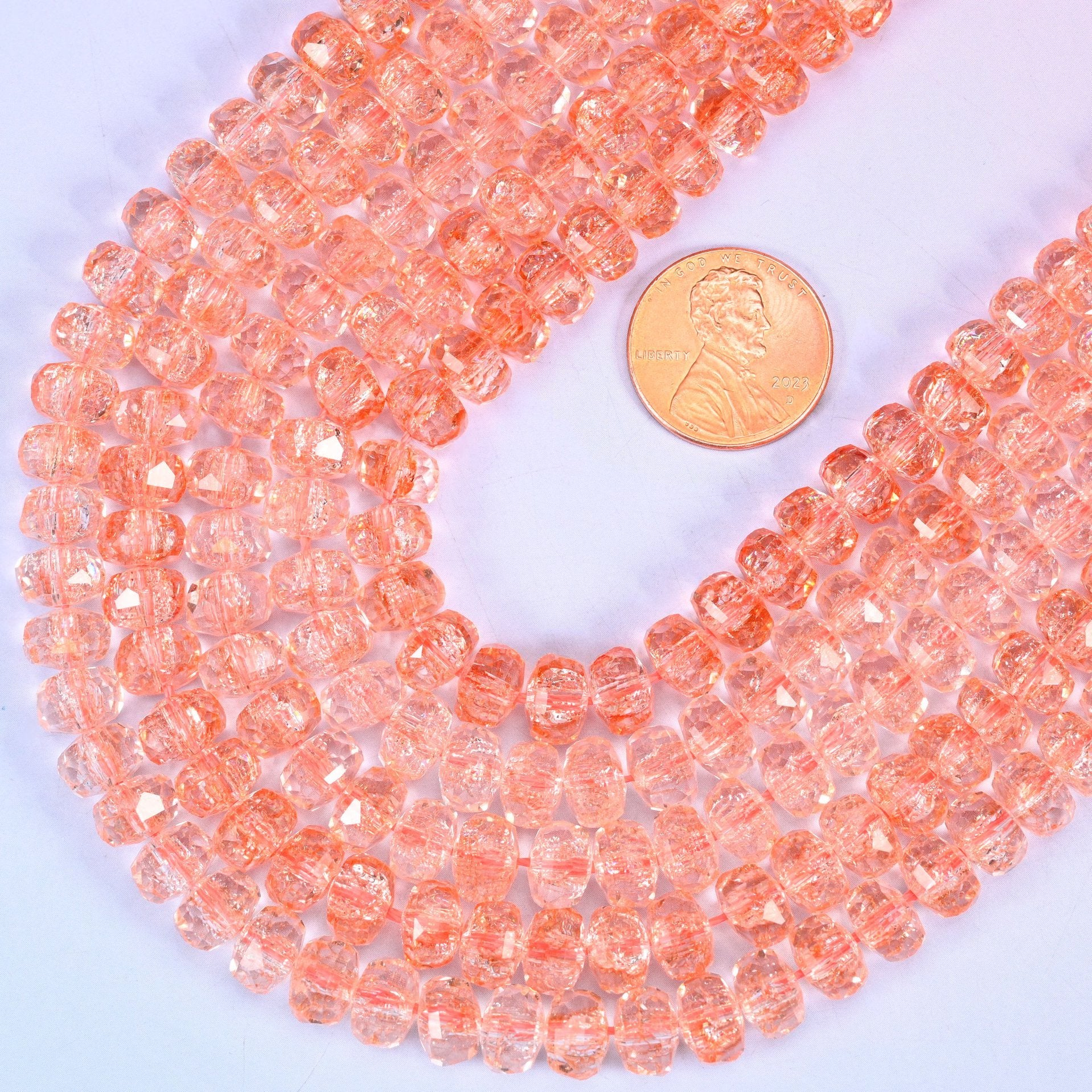 Faceted rondelle cut transparent orange glass beads