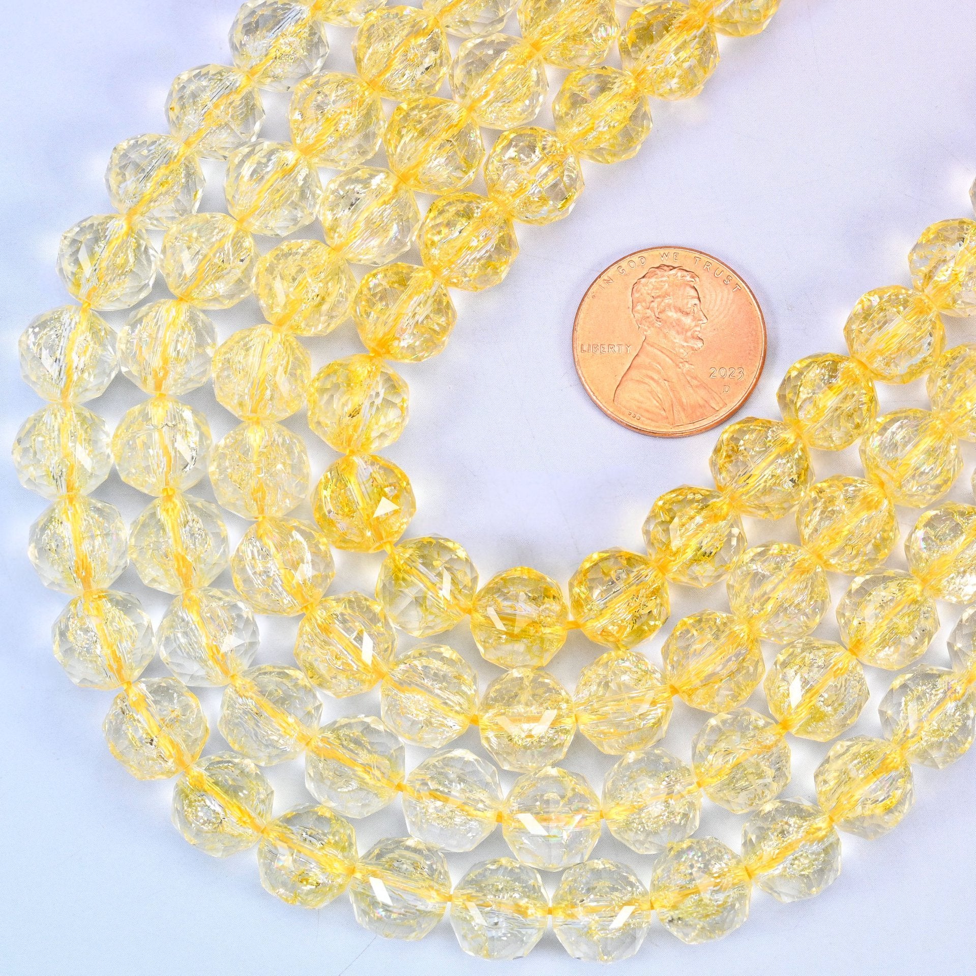 Faceted round cut transparent yellow glass beads