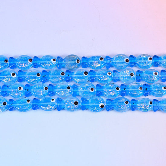Blue fish glass beads in translucent cornflower blue with silvery glitter inclusions