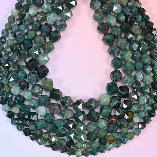 Moss Agate beads coiled into a loop, star facets catching light across the dark green and cloudy white stone