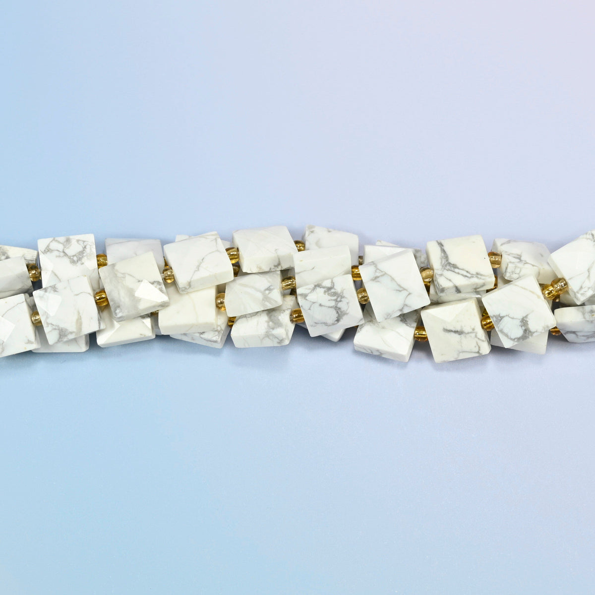 Strands of white howlite faceted flat square beads twisted together in a horizontal row