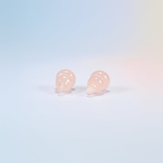 Top view of two natural rose quartz gourds showing the carved stem