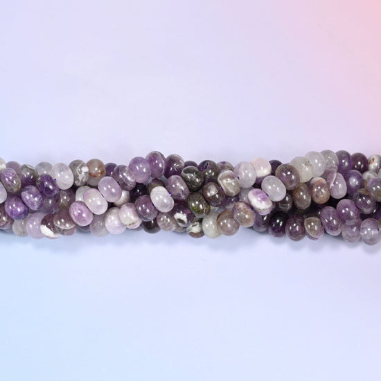 Close-up of coiled Amethyst beads showing the natural texture and white quartz veining.