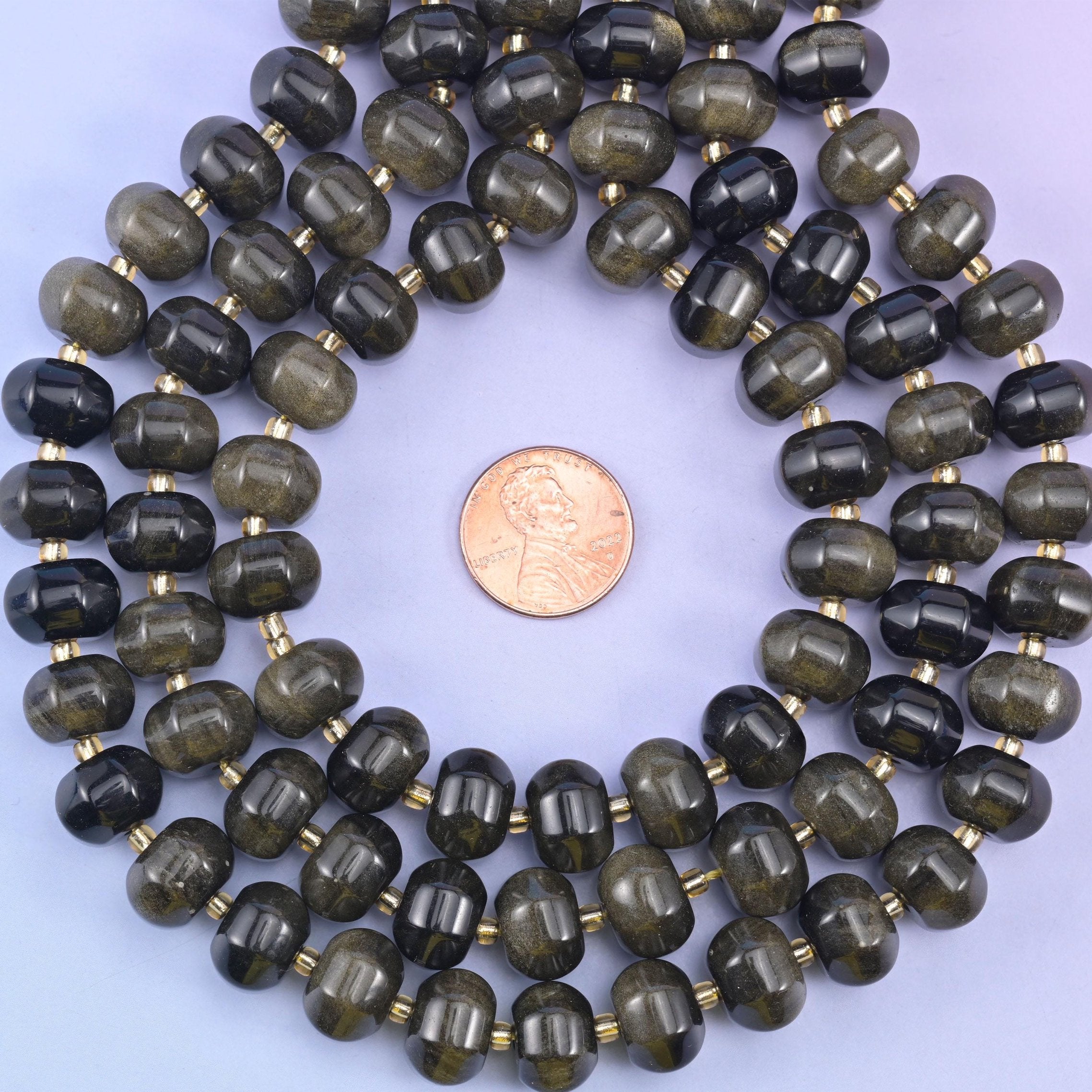 Gold obsidian smooth pumpkin beads, glossy black stone with a shimmering golden sheen