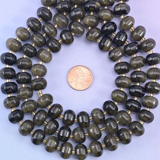 Gold obsidian smooth pumpkin beads, glossy black stone with a shimmering golden sheen