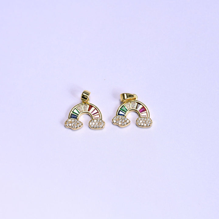Two gold Rainbow Zirconia Charms side by side, 18K gold plated arcs of multicolor baguette zirconia resting on pave zirconia clouds.