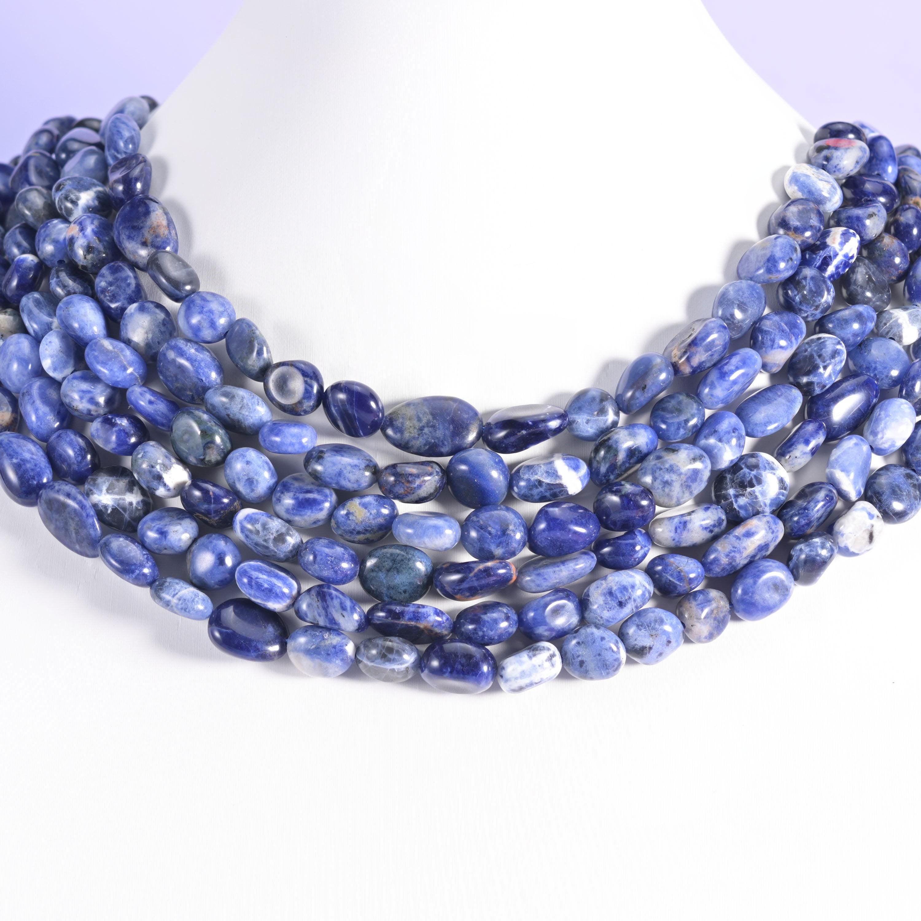 Sodalite pebble nugget strands draped across a white neck display form