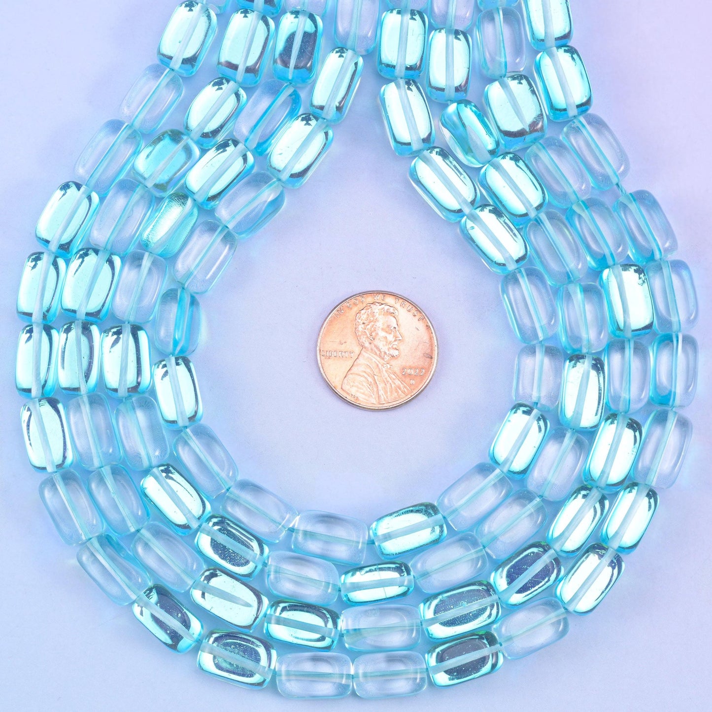 Light blue mystic aura rectangle glass beads, glossy transparent finish with fresh aqua-blue shine