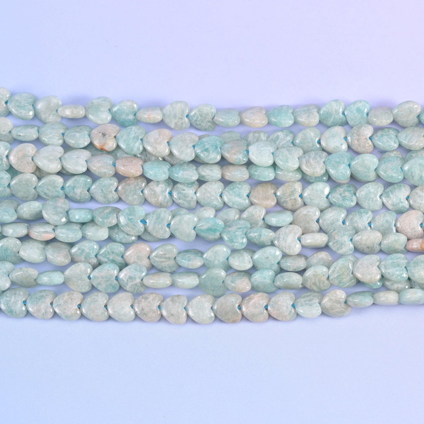 Close horizontal view of Blue Amazonite hearts with creamy beige patches