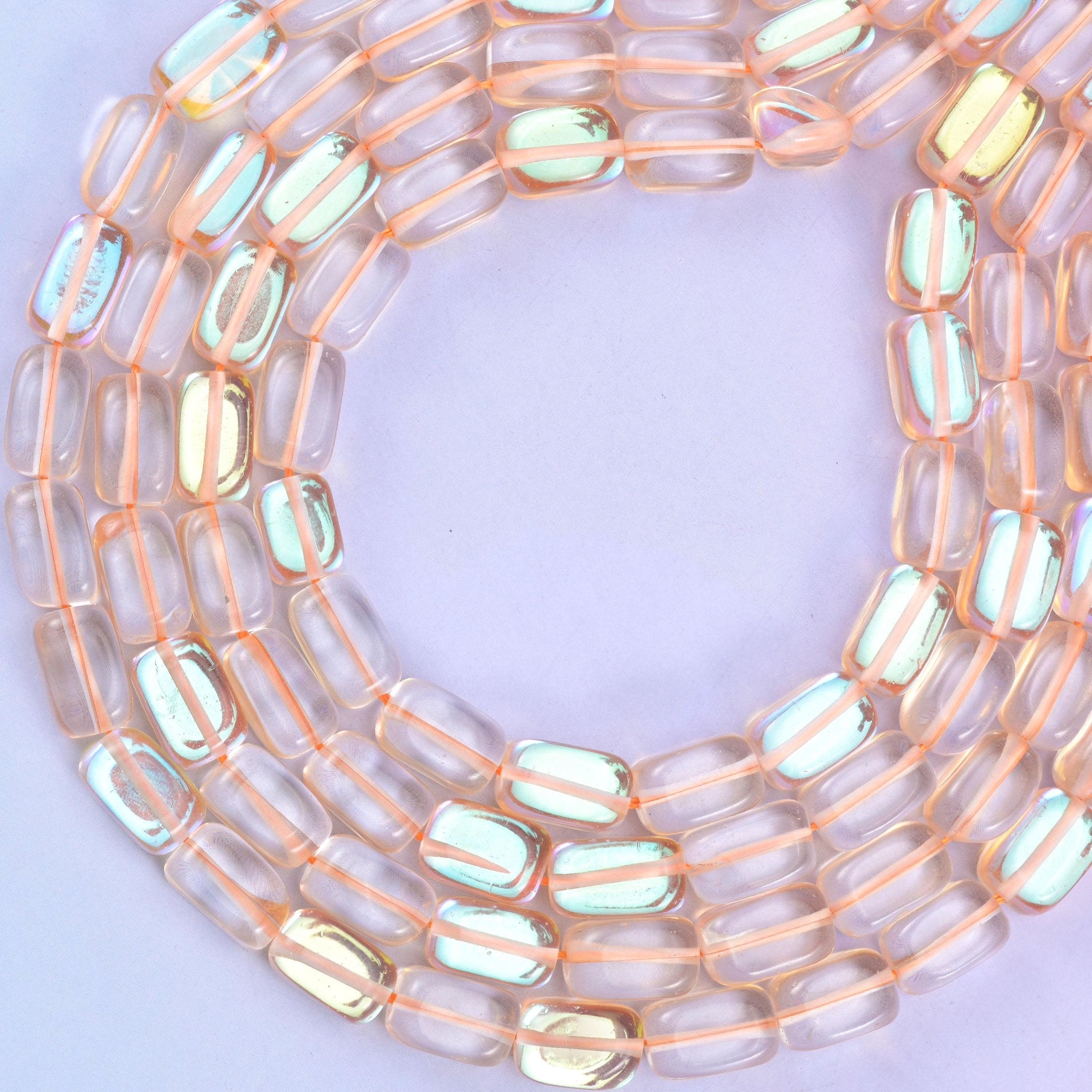 Orange Mystic Aura glass beads, approximately 34 beads per strand