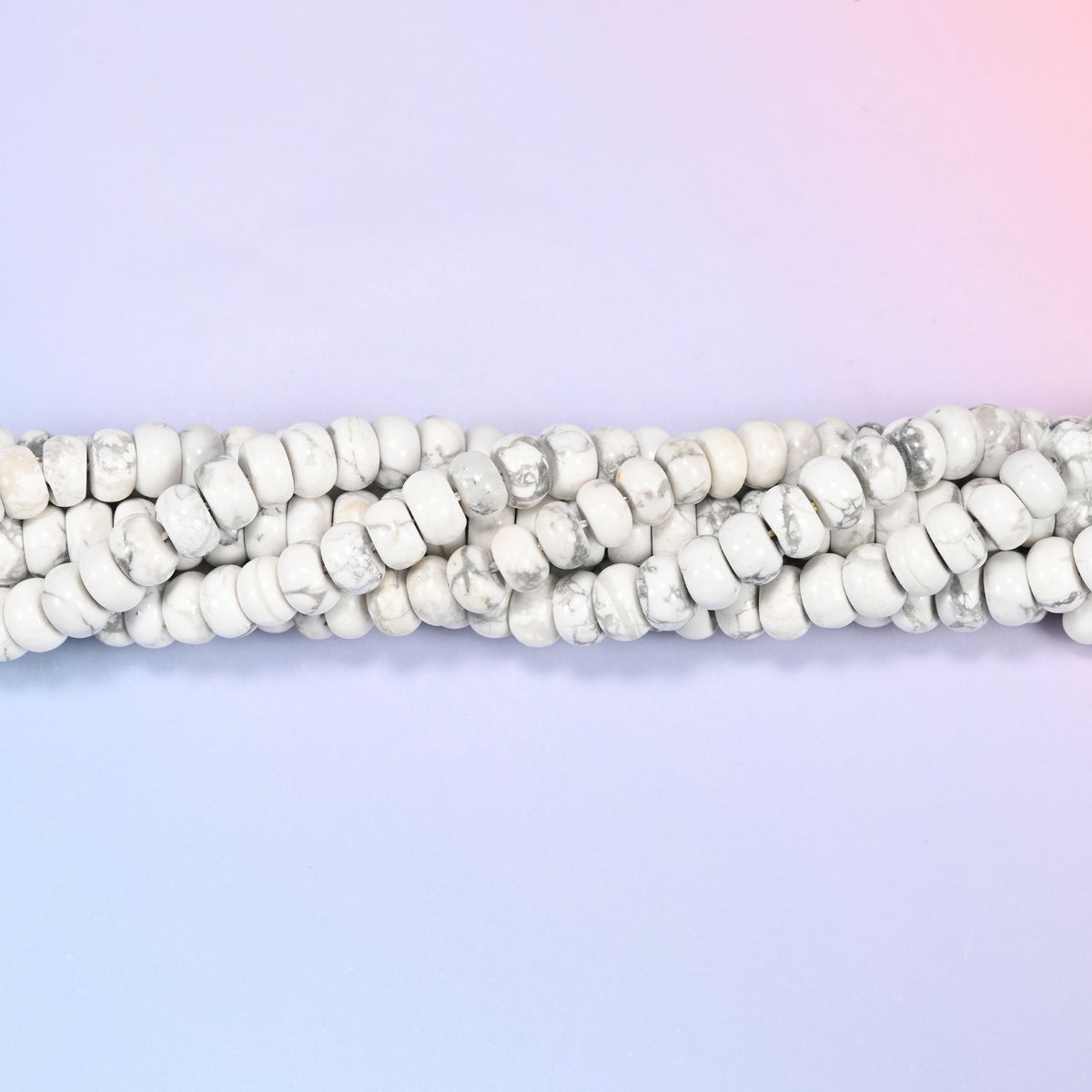 Natural White Howlite rondelle beads in a soft white base with gray marbled veining.