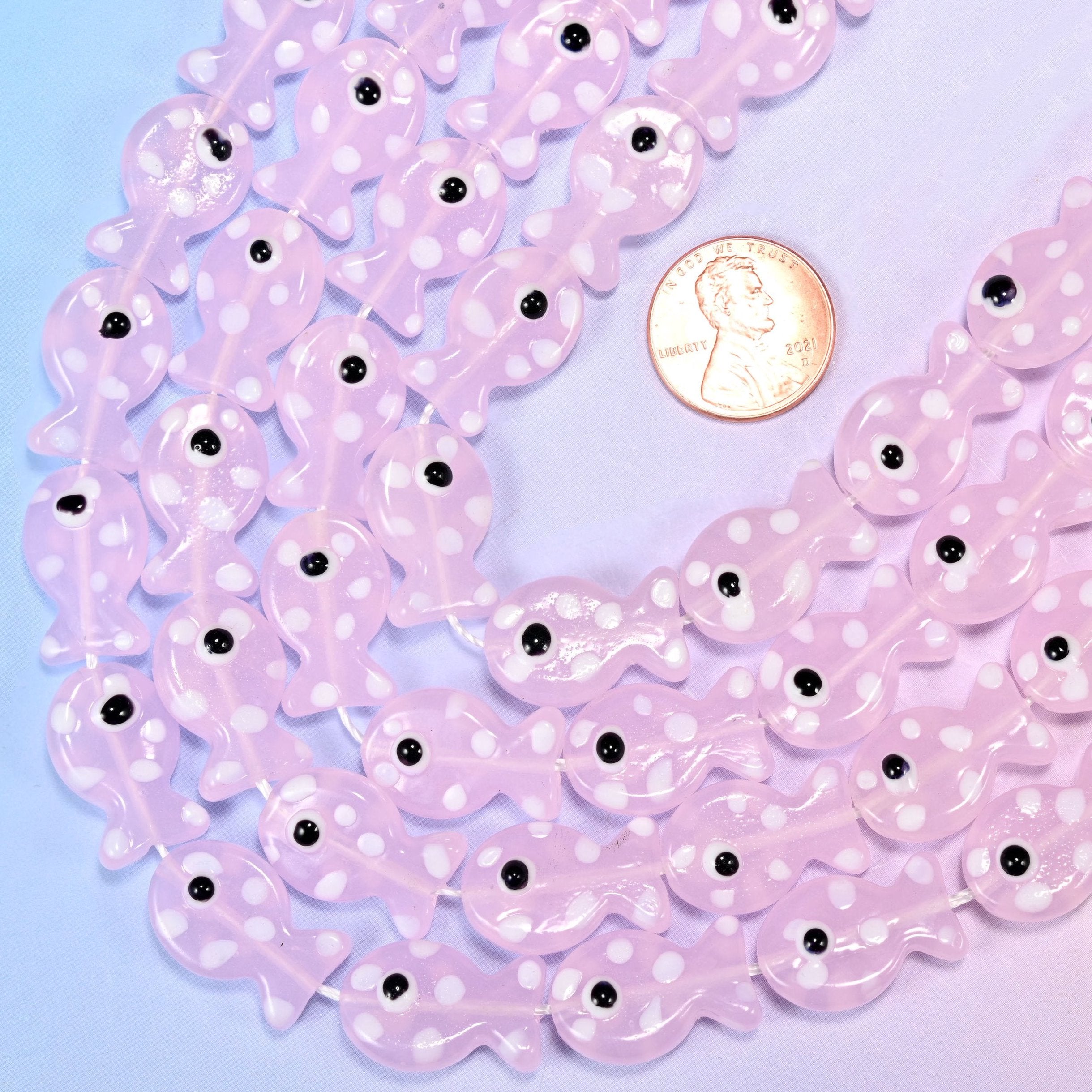 Fish-shaped pink glass beads with white dot pattern