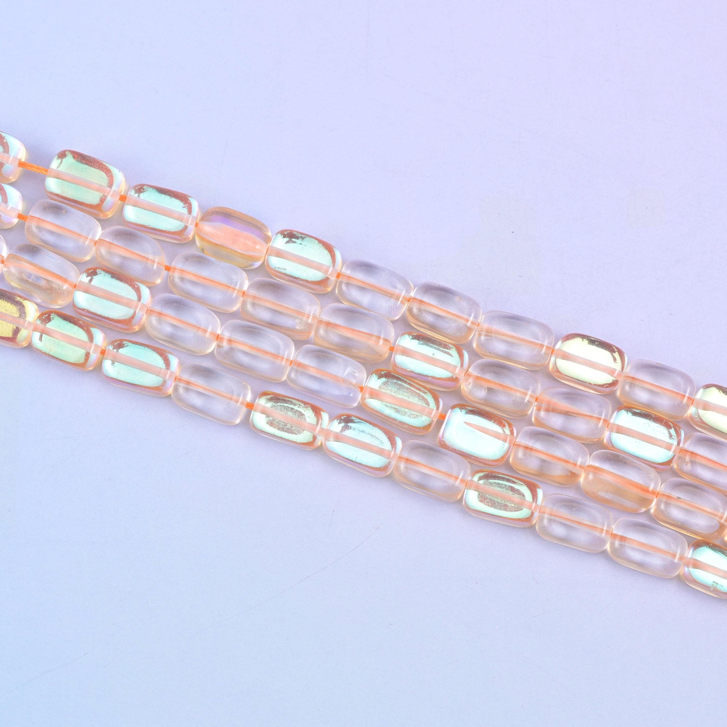 Orange Mystic Aura glass beads in a warm amber-orange shine with a subtle iridescent glow