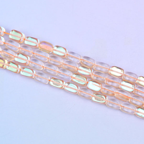 Orange Mystic Aura glass beads in a warm amber-orange shine with a subtle iridescent glow