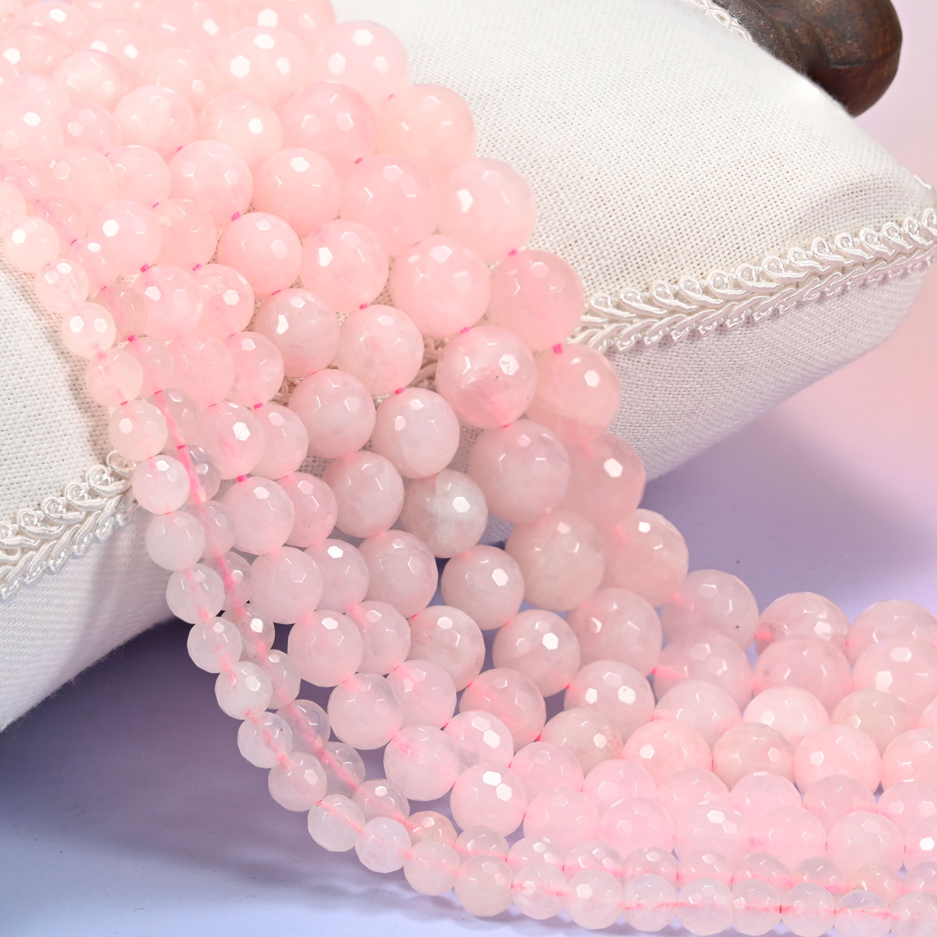 Pink rose quartz faceted round beads in 6mm, 8mm, 10mm, and 12mm, 15-inch strand, for jewelry making.